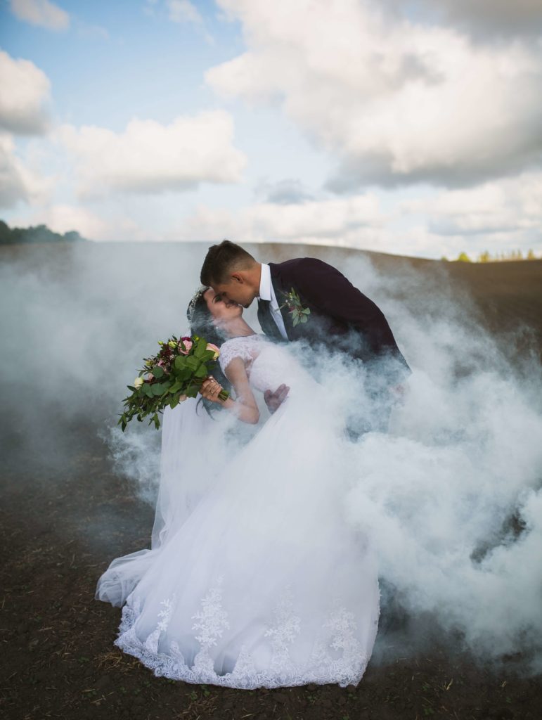 Epic photo of a wedding couple surrounded by smoke