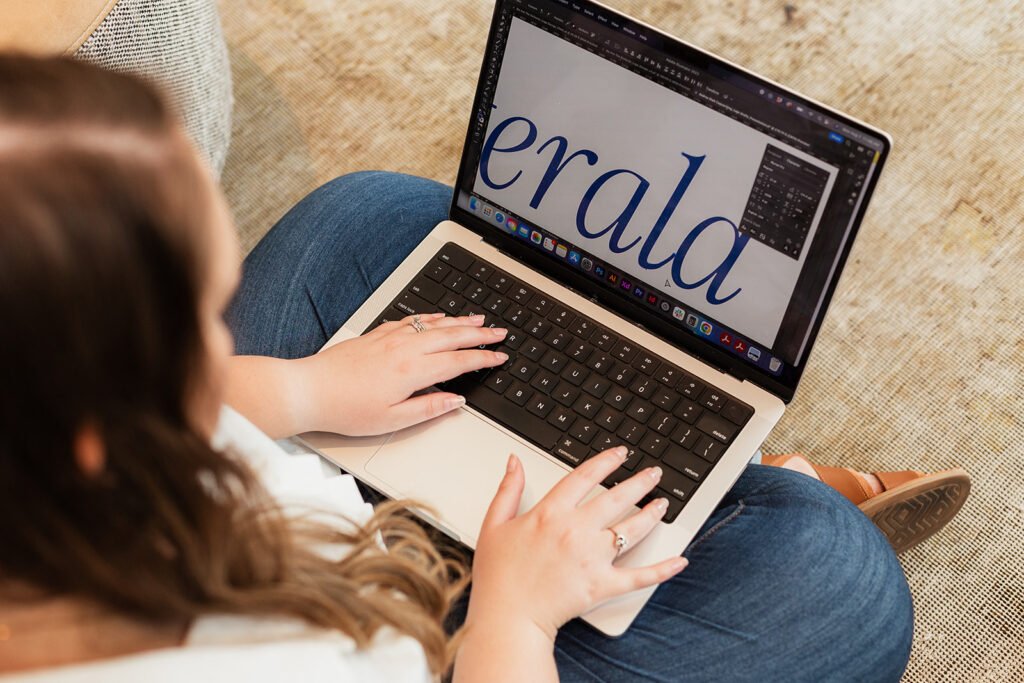 woman working on typography design project on a laptop