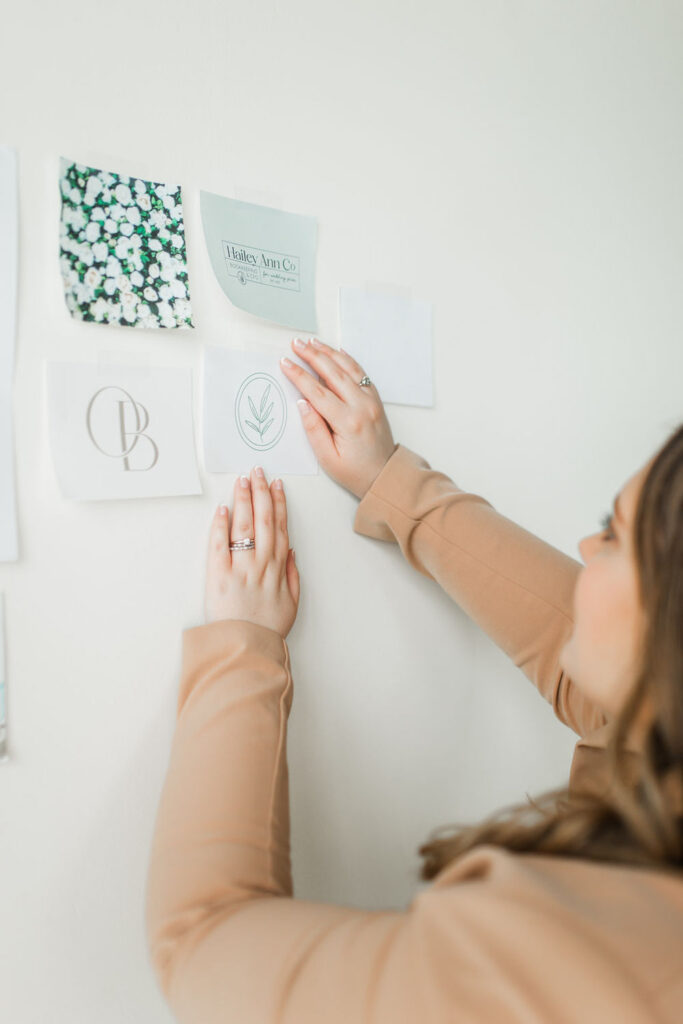 Close-up pinning brand materials on wall
