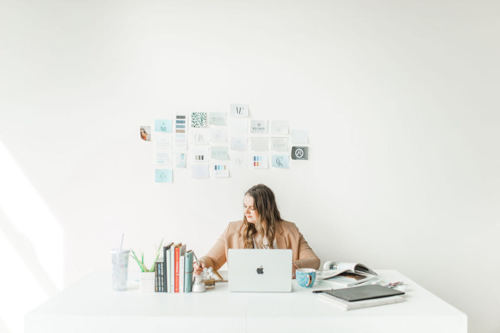 Emily at desk with inspiration wall