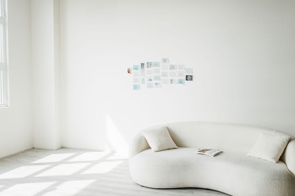 Branding mood board on white wall in bright, minimal studio