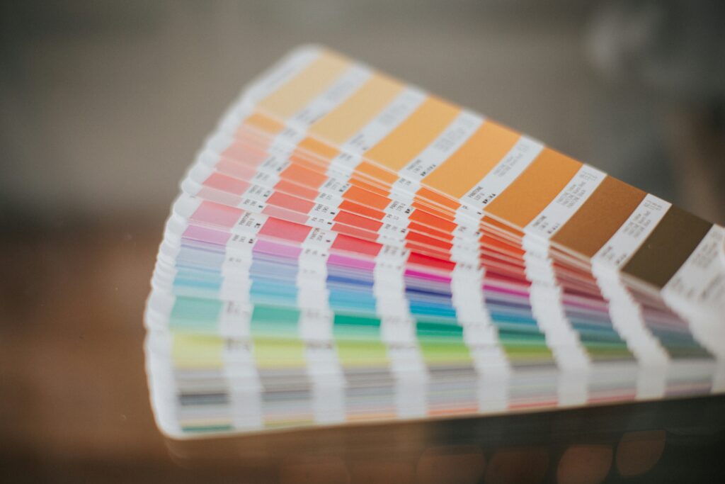 Close-up of colorful Pantone swatches fanned out, showing warm and cool color ranges