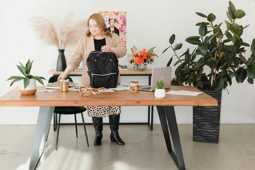 Cinthia standing beside her wooden table