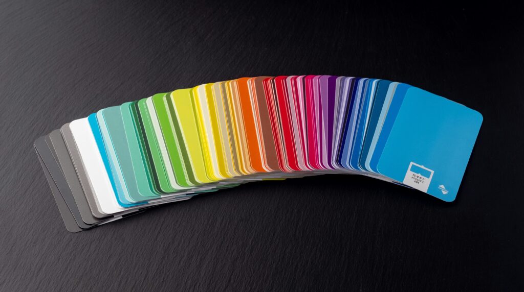 Spread of colorful paint swatches arranged on a black surface