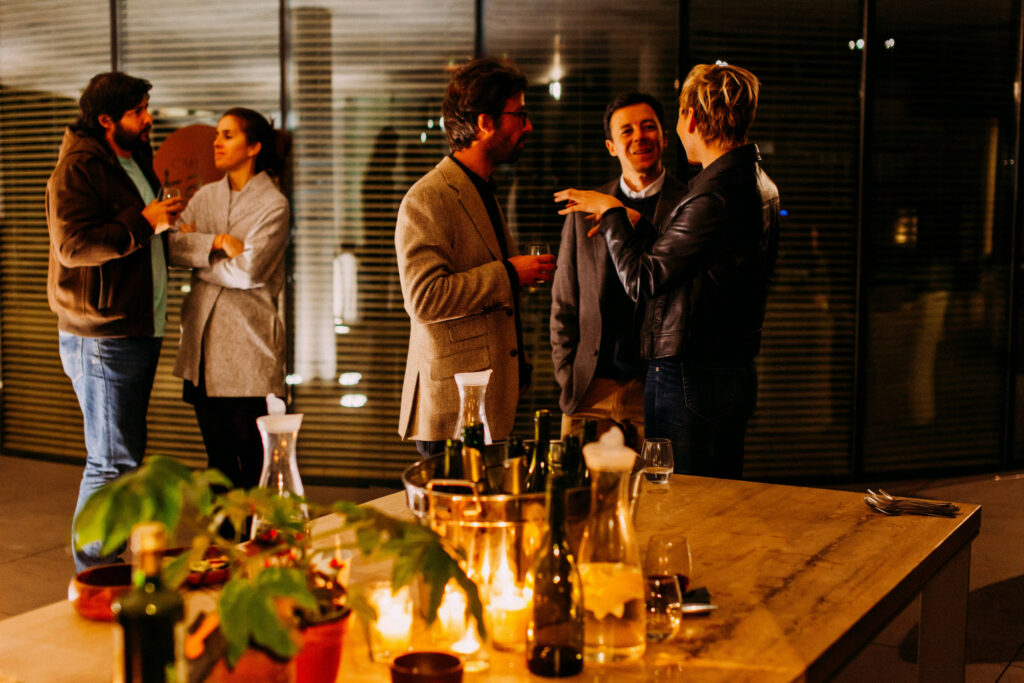 Group of professionals networking at evening gathering