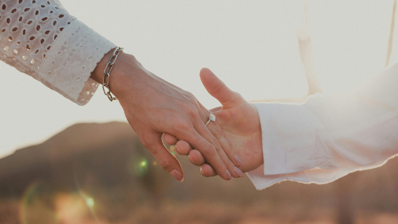 Newly engage couple holding hands
