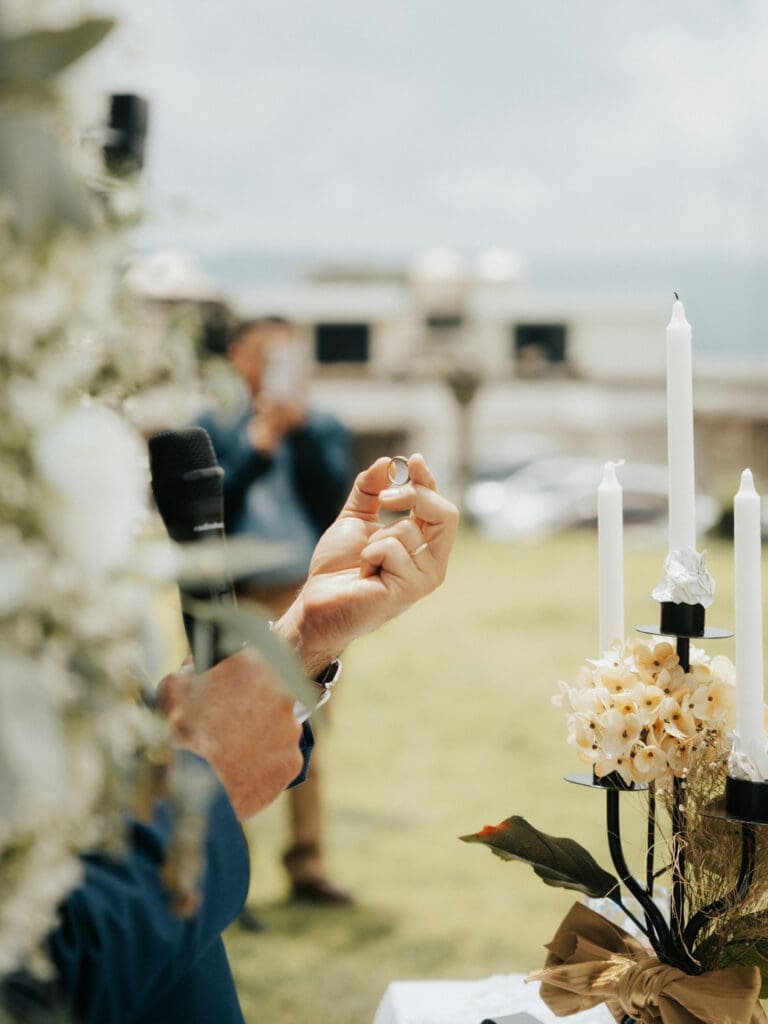 Wedding vendors capturing and adjusting details during an outdoor wedding setup