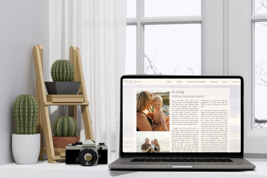 Laptop displaying a photography blog post beside cameras and plants