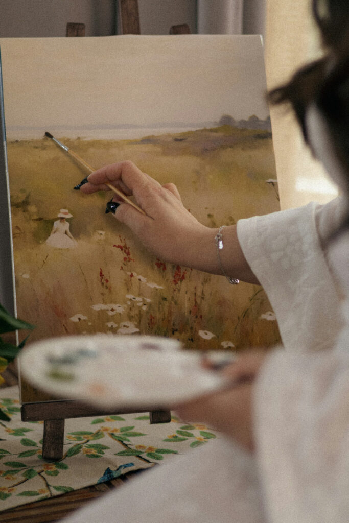 Artist painting a landscape on canvas