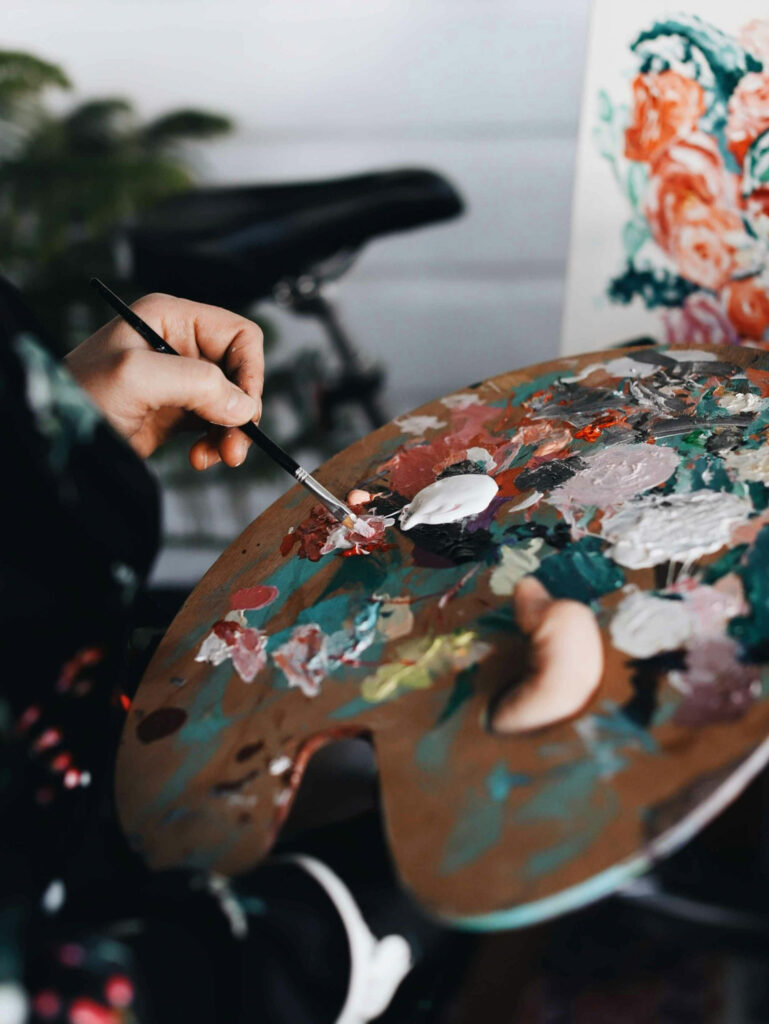 Artist mixing paint on a palette