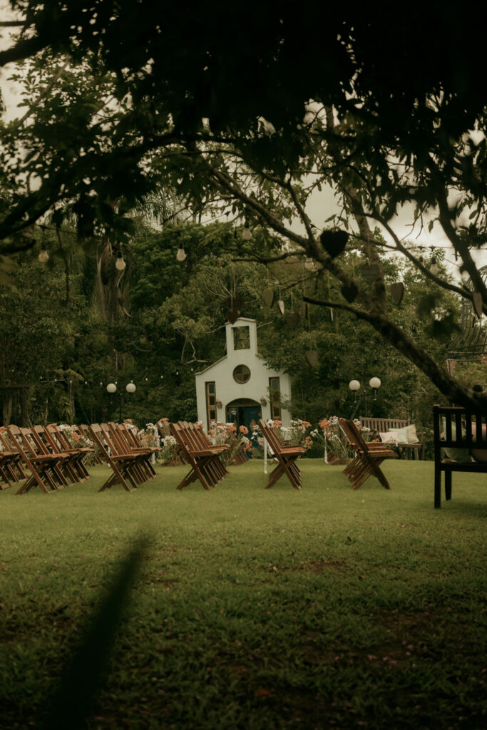 Outdoor wedding ceremony setup with wooden chairs