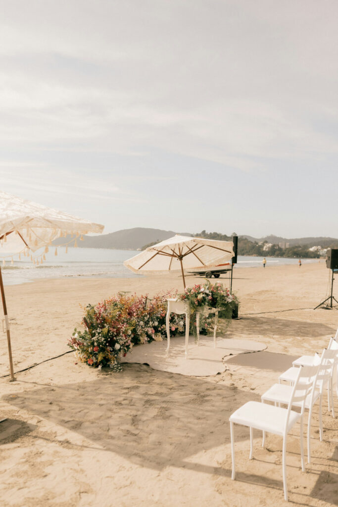 Beach wedding ceremony setup with florals