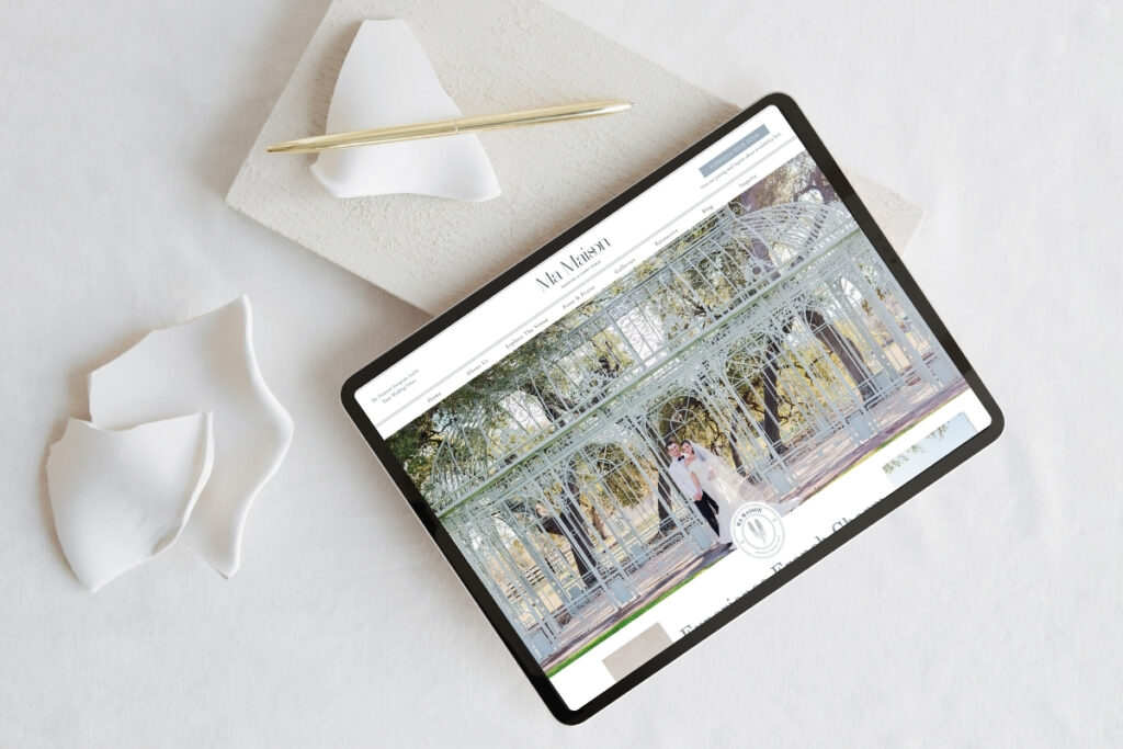 Tablet showing wedding venue website mockup with white stationery