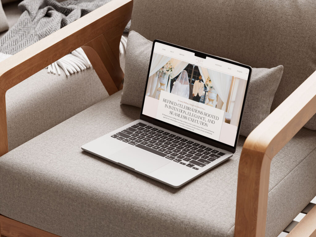 Laptop showing wedding planner website on cushioned chair