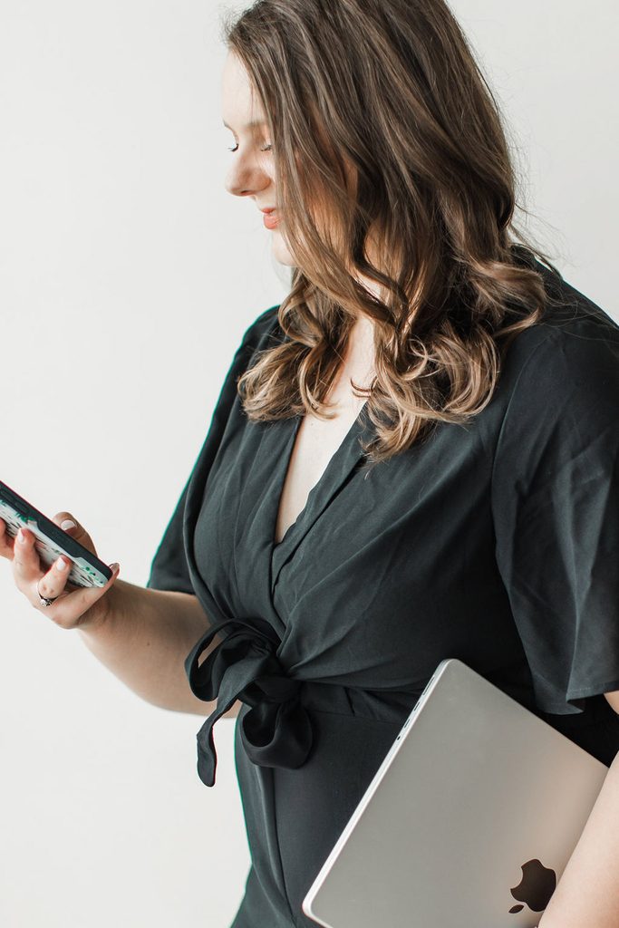 Woman looking at her phone and using the Interact quiz builder to make a quiz for her wedding industry business.