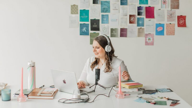 Woman recording a podcast at her desk