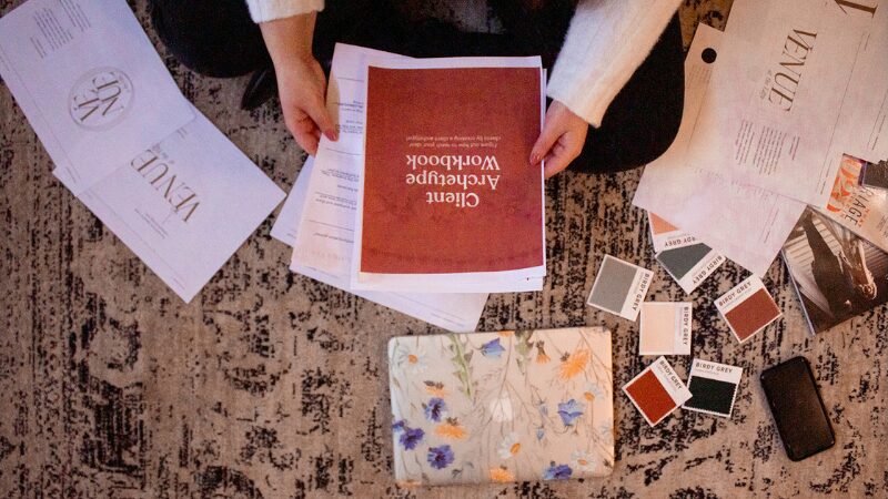 Branding workbook and color swatches spread on the floor