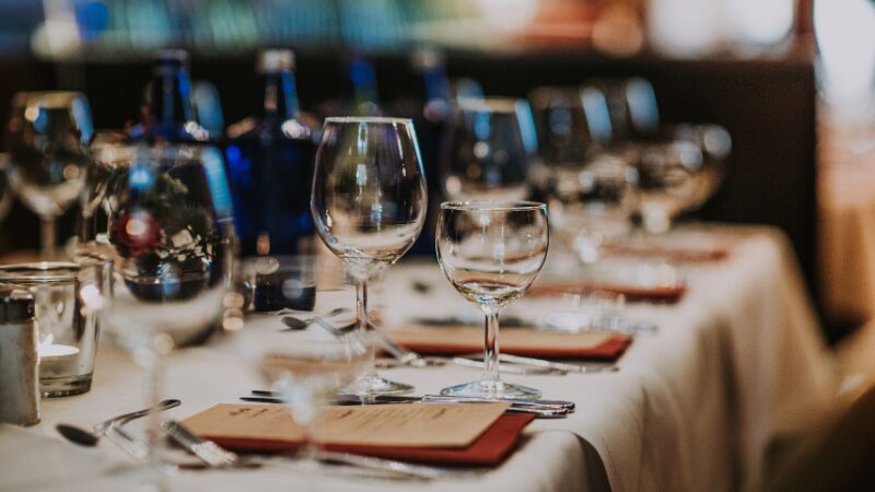Elegant wedding reception table with glassware and place settings.