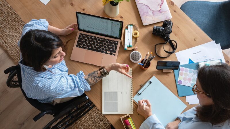 Two women planning together at a desk