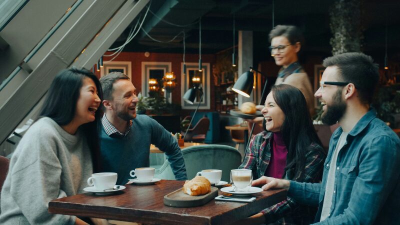 Group of friends talking over coffee at a cafe